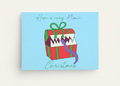 A square light blue Christmas greeting card featuring a cartoon xmas mimic with the text 'Have a very Mimic Christmas' in green and purple script.