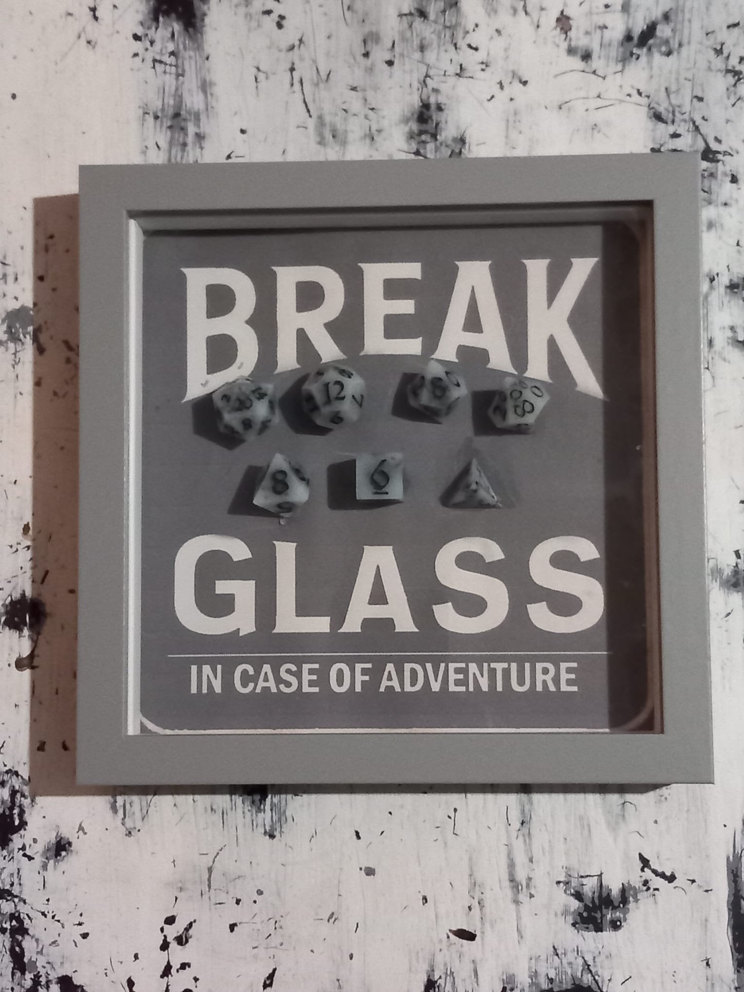 Wall Art Box Frame that has a vintage sign style background and says Break Glass in case of Adventure with a set of 7 polyhedral Dice inside.