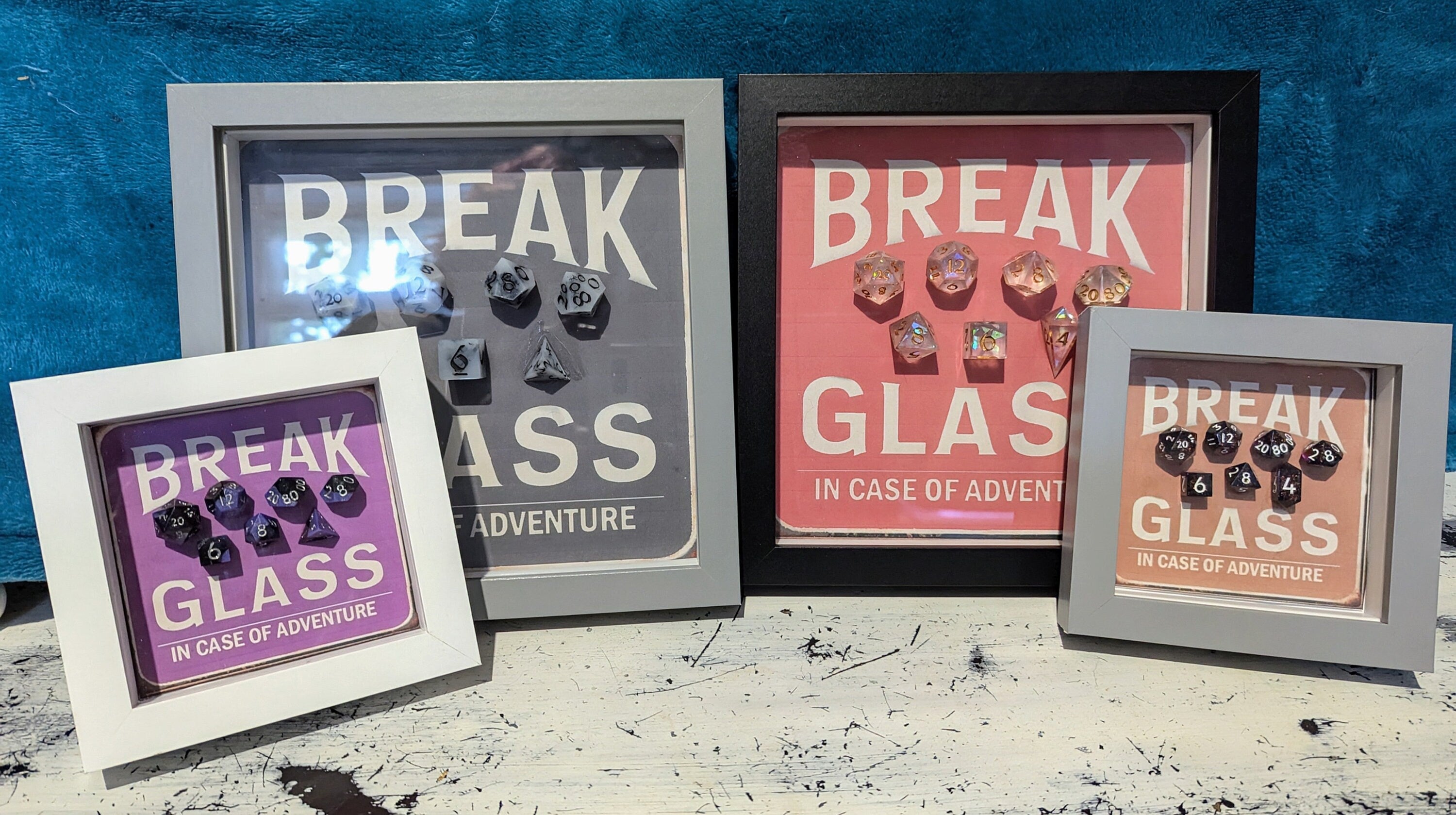 Wall Art Box Frame that has a vintage sign style background and says Break Glass in case of Adventure with a set of 7 polyhedral Dice inside.