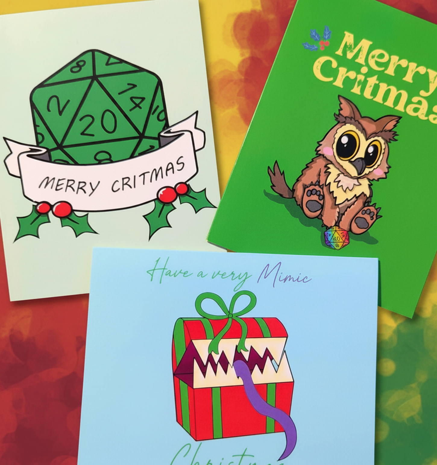 Three Christmas greeting cards arranged on a colorful background. One card shows a green 20-sided die with 'MERRY CRITMAS' text and holly accents.